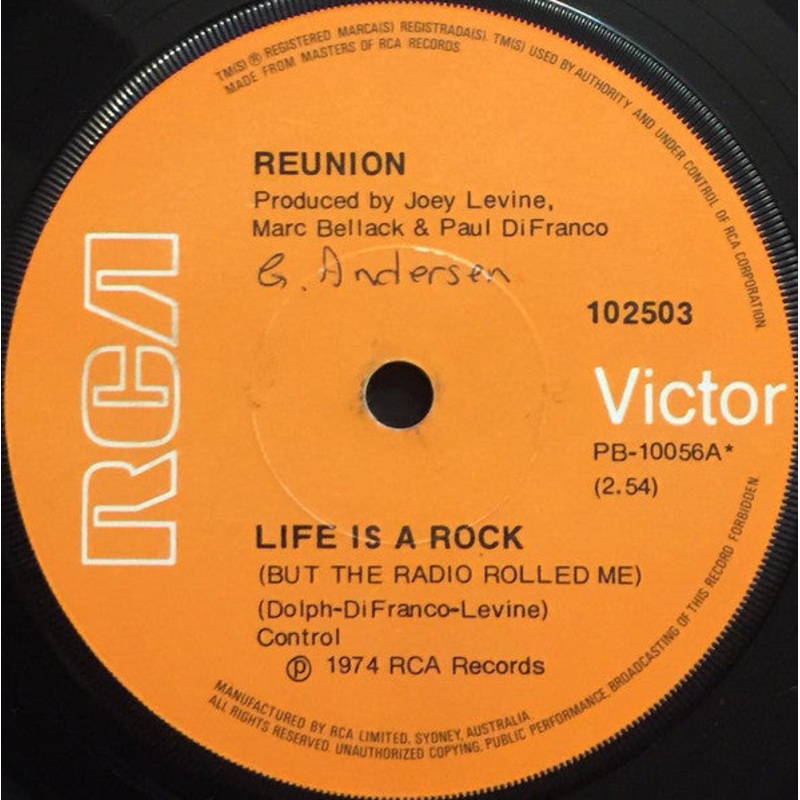 Reunion  – Life Is A Rock (But The Radio Rolled Me) (7, Single) (Very Good Plus (VG+))